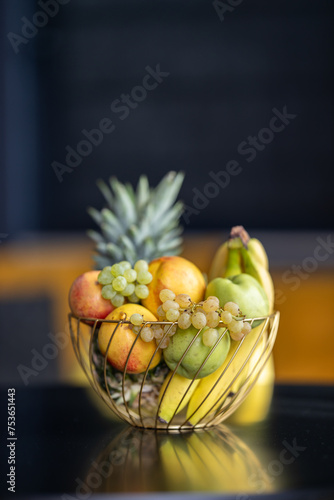 Fotografie Fruit basket on the table in bright kitchen with blurred background for decorati