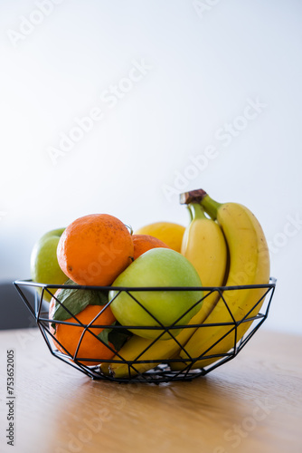 Fototapeta Naklejka Na Ścianę i Meble -  Fruit basket on the table in bright kitchen with blurred background for decoration