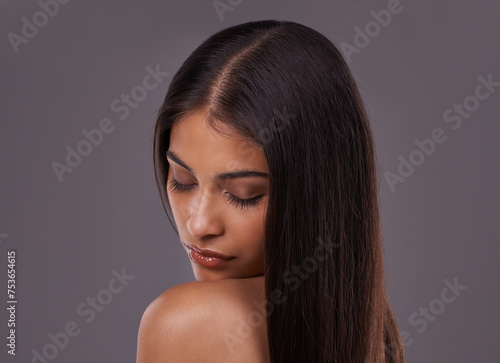 Beauty, hair and face of woman in on gray background for healthy texture, wellness and hairstyle. Haircare, hairdresser and person with eyes closed for salon products, cosmetics and shine in studio