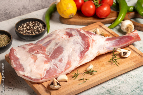 Lamb shoulder meat with bones. Butcher products. Raw lamb shoulder on stone ground