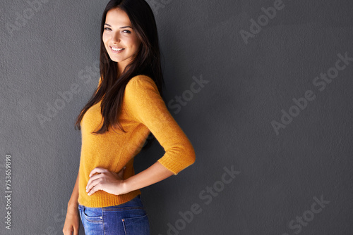 Portrait, trendy and woman in studio, fashion and cool style in gray background. Female person, smile and happy with confidence or pride in mockup space, stylish and edgy in casual outfit or clothes