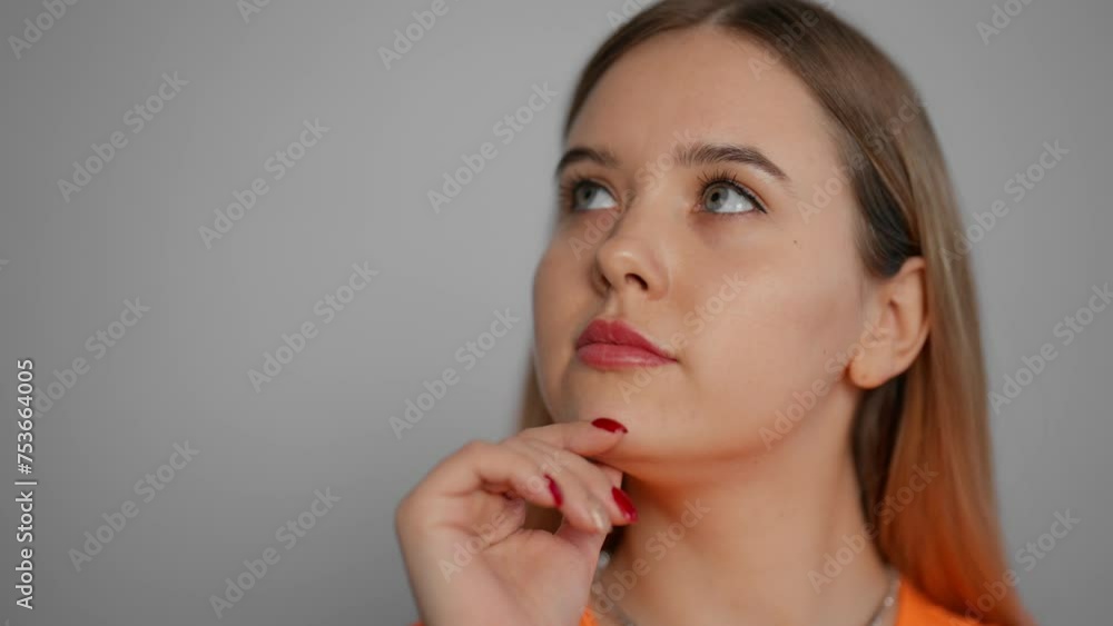 Young woman thinking to solve a problem. Pensive girl thoughtfully at idea hold hand to chin with gesture of thought about problem solution with puzzled facial expression close up. Decision concept. Young woman thinking to solve a problem. Pensive girl thoughtfully at idea hold hand to chin with gesture of thought about problem solution with puzzled facial expression close up. Decision concept.