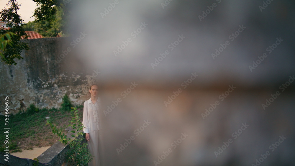 Obraz premium Woman tourist standing old castle leaning on fence. Girl posing at old building