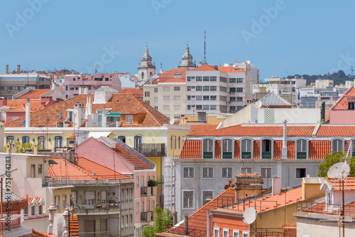 Cityscape of colorful traditional houses in Lisbon historic center, Portuguese red rooftops, balconies, antenna, and construction, Portugal