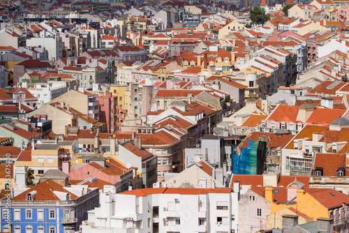 Lisbon skyline panorama, red rooftops cityscape and diagonal street seen from Miradouro da Senhora do Monte in Portugal.