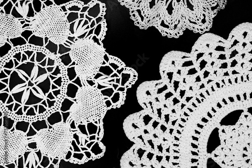 Vintage white knitted napkin isolated on a black background photo