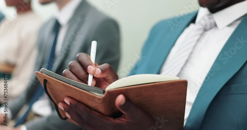 Businessman, hands and writing with book in row for notes, presentation or waiting room at the office. Closeup of man or employee filling notebook in line for schedule or attention at the workplace photo