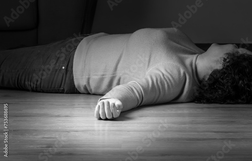 Body of woman lying on ground, contract killing, revenge or robbery, horror or domestic violence, black and white photo