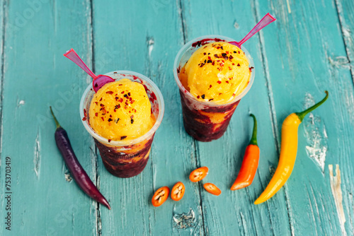 Mexican spicy fruit ice cream against colorful background