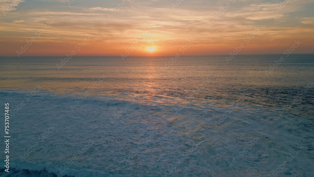 Fototapeta premium Bright sunset shining sea surface drone view. Stunning summer sun setting down
