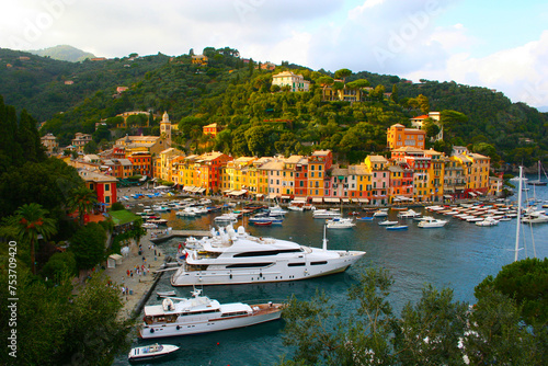 Portofino with its colorful houses and luxurious villas, yachts and boats in the small marina in the bay. Liguria, Italy, Europe..