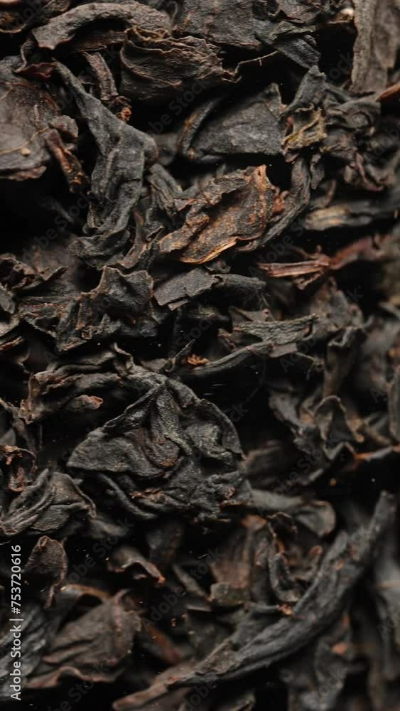 Vertical video. Dry black tea leaves, macro background, rotating in a jar. Vertical video. Dry black tea leaves, macro background, rotating in a jar.