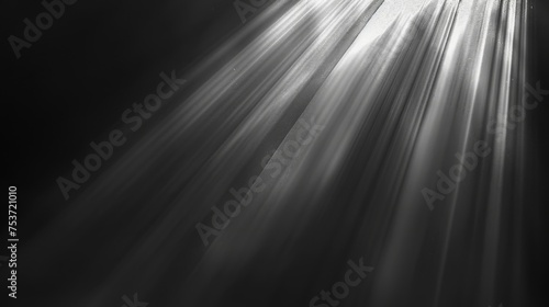 Soft-focus light rays on a black and white gradient background