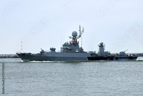 Russian warship armed with armament sails into sea toward military target to attack and destroy enemy, military ship performing strategic maneuver, Russian sea power deployment for tactical advantage