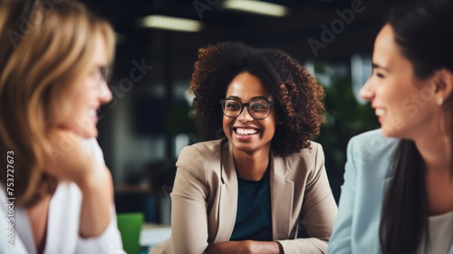 A group of diverse, confident, women working together, smiling, in an office, business environment photo