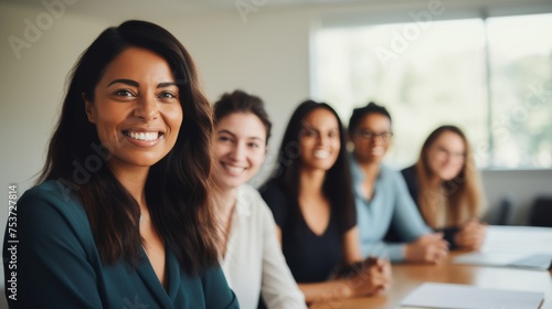 A group of diverse, confident, women working together, smiling, in an office, business environment
