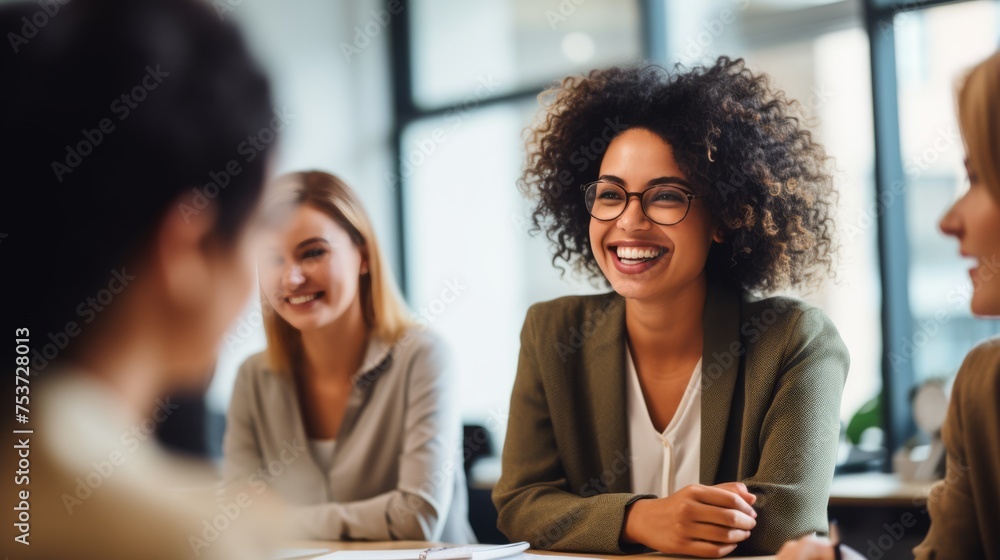 A group of diverse, confident, women working together, smiling, in an office, business environment A group of diverse, confident, women working together, smiling, in an office, business environment
