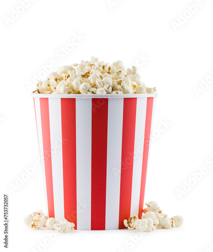 Popcorn in red and white striped container, isolated on white background.