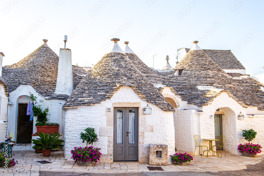 Alberobello Italy - traditional trulli houses with conical stone roofs. Famous landmark, travel destination and tourist attraction near Bari in Puglia, Europe. Old Mediterranean architecture.