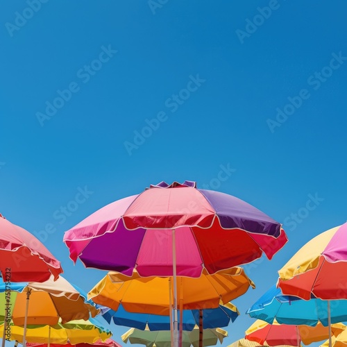 Colorful Beach Umbrellas Under a Clear Blue Sky on a Sunny Day