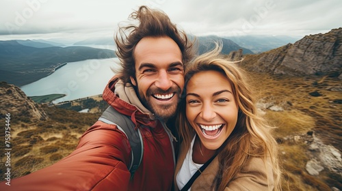 cheerful couple taking selfie photo standing on mountains.