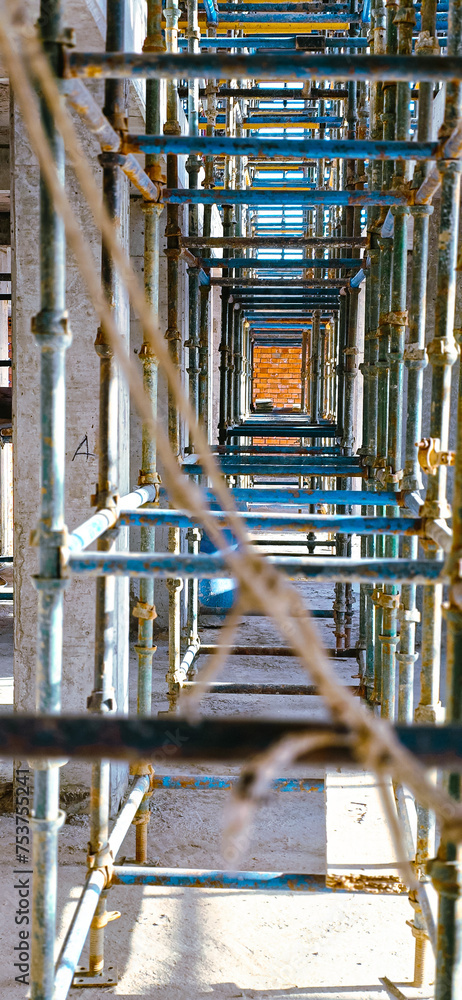 A long row of scaffolding with a rope hanging down