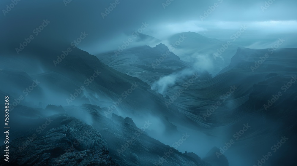 Fototapeta premium a view of a mountain range in the distance with a dark sky in the background and clouds in the foreground.