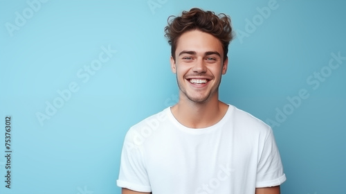 Caucasian man wearing a t-shirt on a blue background.