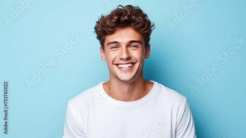 Caucasian man wearing a t-shirt on a blue background.