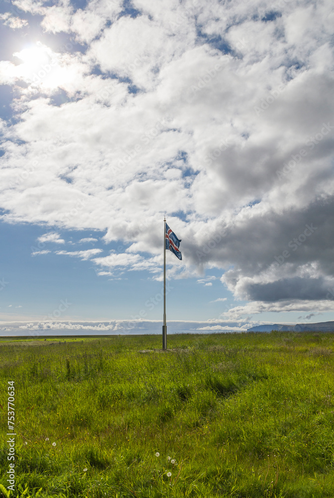 iceland flag fluttering on a flagpole at the rauðisandur beach in iceland on a cloudy day iceland flag fluttering on a flagpole at the rauðisandur beach in iceland on a cloudy day