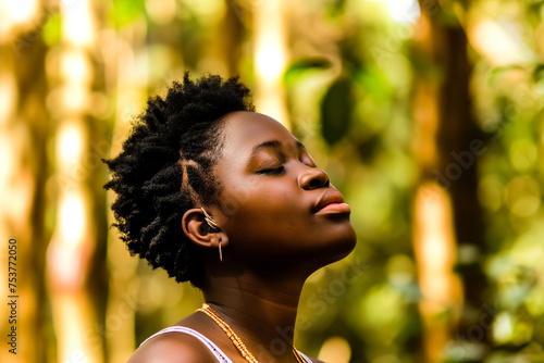 Serene moment captured of black woman enjoying natures embrace during golden hour. View from the side