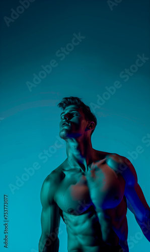 Portrait of an athletic man looking up against a dark background background