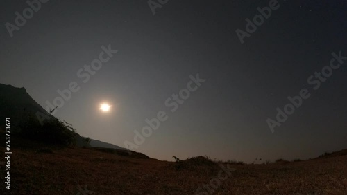 The moon rises from the sky on a full moon day. Location at national park in Vientiane, Laos. photo