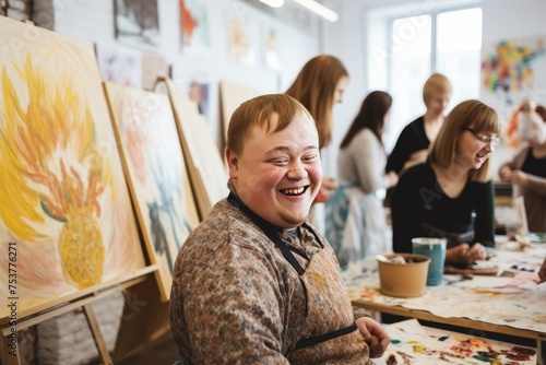 Young smiling man with Down syndrome on art workshop with a group of students high resolution --ar 3:2 Job ID: 0603460f-86c9-4799-8c97-3f08a5ee9b80