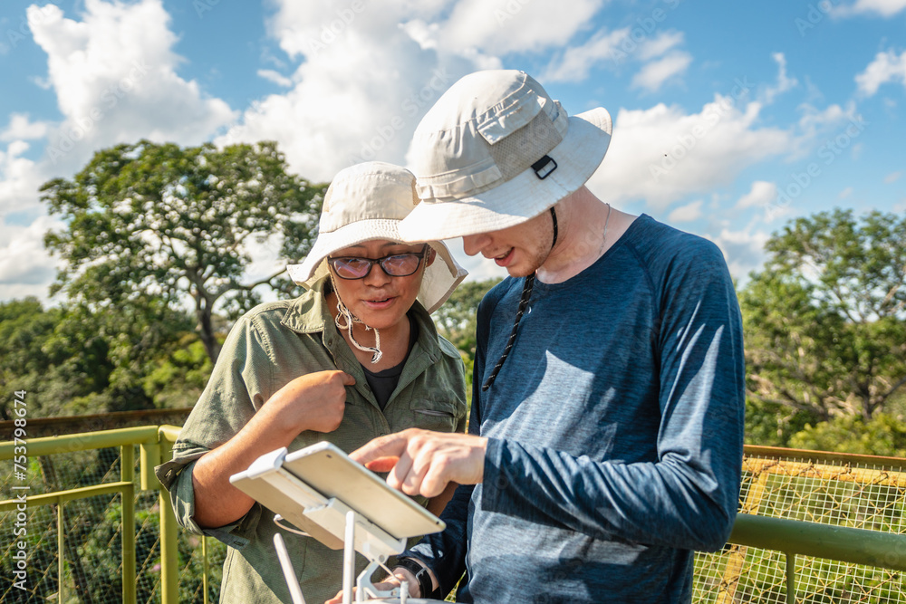 Couple flying drone in nature Couple flying drone in nature