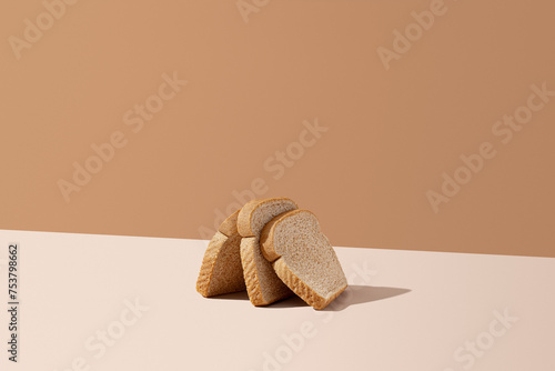 Pieces of Fresh Bread On A Light Brown Background With Copy Space