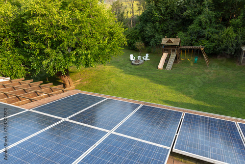 Solar Panels  House roof view to backyard  with outdoor swingset  photo