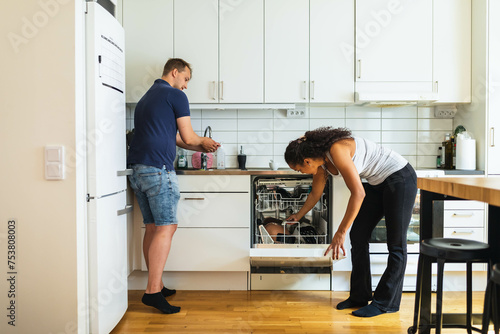 Friends cleaning kitchen photo