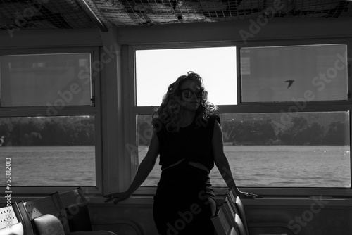 Black and white photo of a woman on a river tram photo