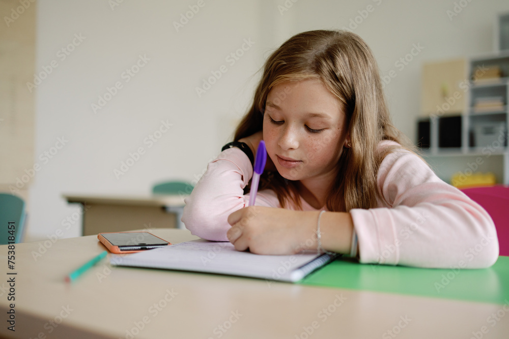 Focused education elementary smart student writing Focused education elementary smart student writing