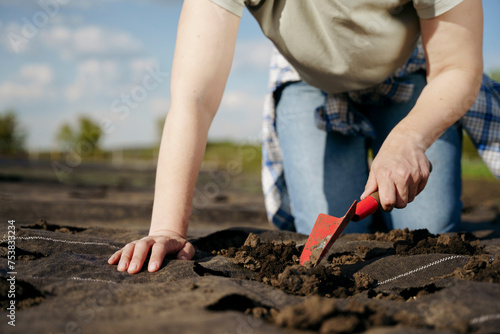 A woman digs up the ground for planting