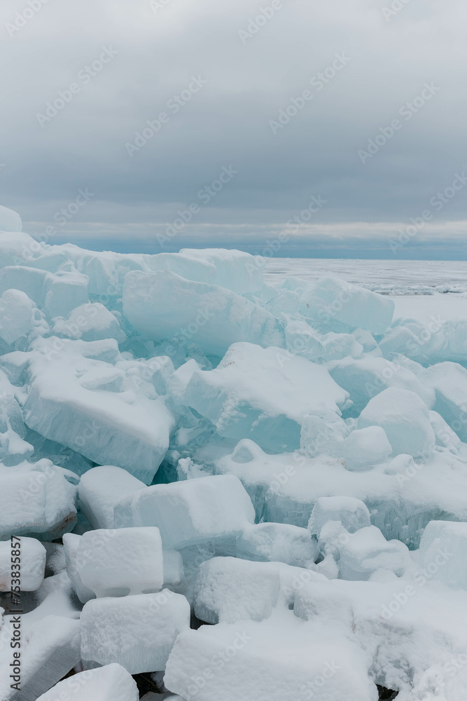 Blocks of ice on the lake in spring. Vertical photo.