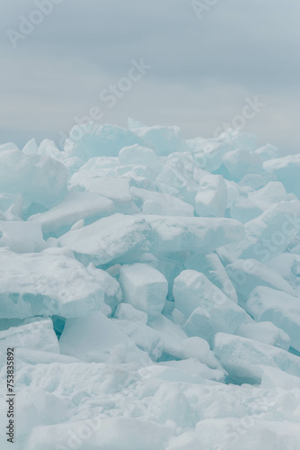 Blocks of ice on the lake in spring. Vertical photo.