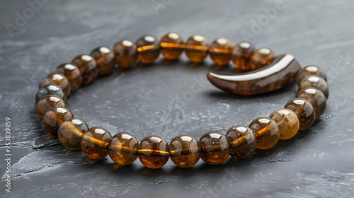 Ramadan-themed crescent-shaped prayer beads on a serene grey background.