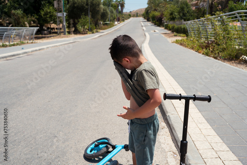 Little Child Beats Heat with T-Shirt on Hot Summer Day. photo