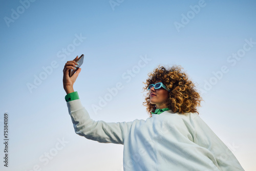 Woman takes a selfie in a clear sky photo
