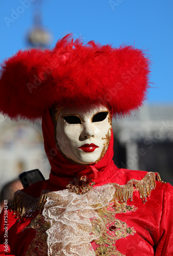 Masked person with big red hat on the head and with white mask © ChiccoDodiFC