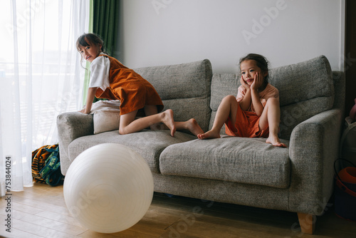 Two sisters having fun in living room photo