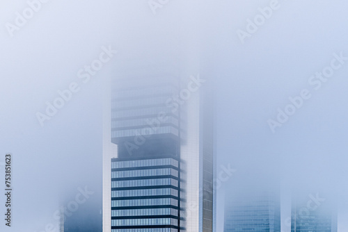 Foggy Day Among Skyscrapers in Urban Landscape. Cityscape in Mist photo