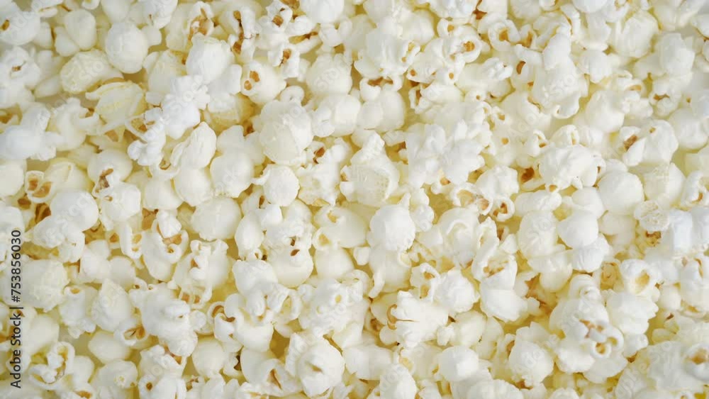 Fresh popcorn snacks in a wooden bowl spinning. Fresh popcorn snacks in a wooden bowl spinning.
